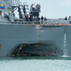 Damage to the USS John S. McCain is visible as it steers towards Changi Naval Base in Singapore following a collision (U.S. Navy photo by Mass Communication Specialist 2nd Class Joshua Fulton/Released)